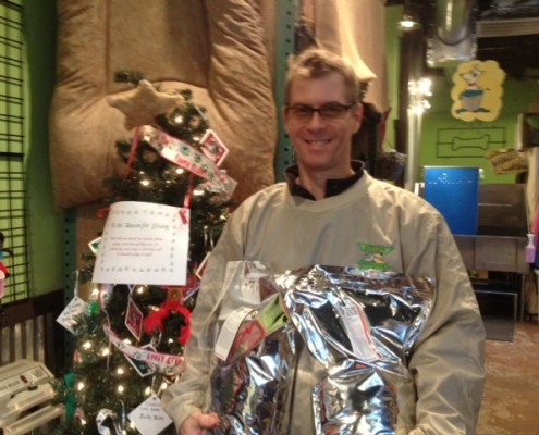 Billy Stalker, IHH employee, with the Angel Tree and some bags of food that were donated.