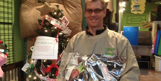 Billy Stalker, IHH employee, with the Angel Tree and some bags of food that were donated.