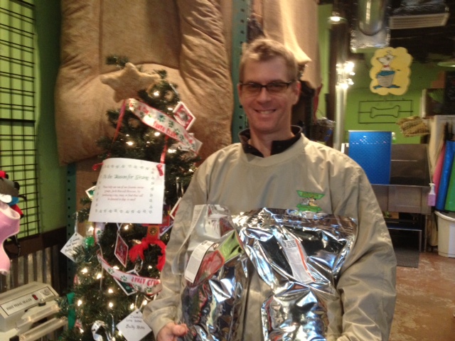 Billy Stalker, IHH employee, with the Angel Tree and some bags of food that were donated.